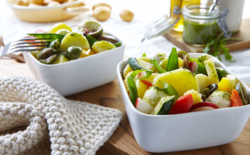 Mediterraner Kartoffelsalat mit Rucolapesto auf dem Esstisch für den Frühlingsstart in die leichte Küche
